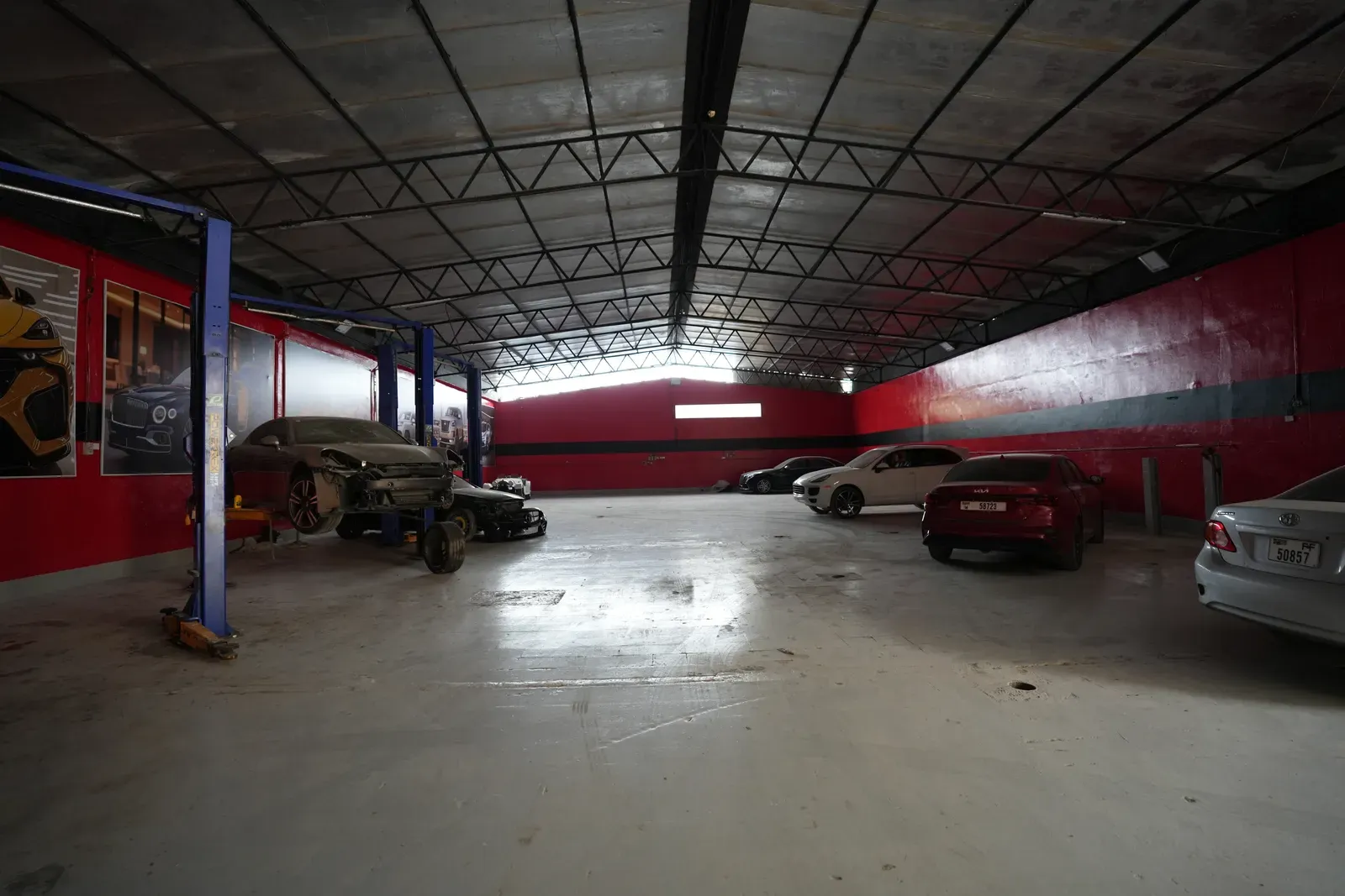 The workshop floor in Sharjah, with cars waiting on and between the two-post lifts.