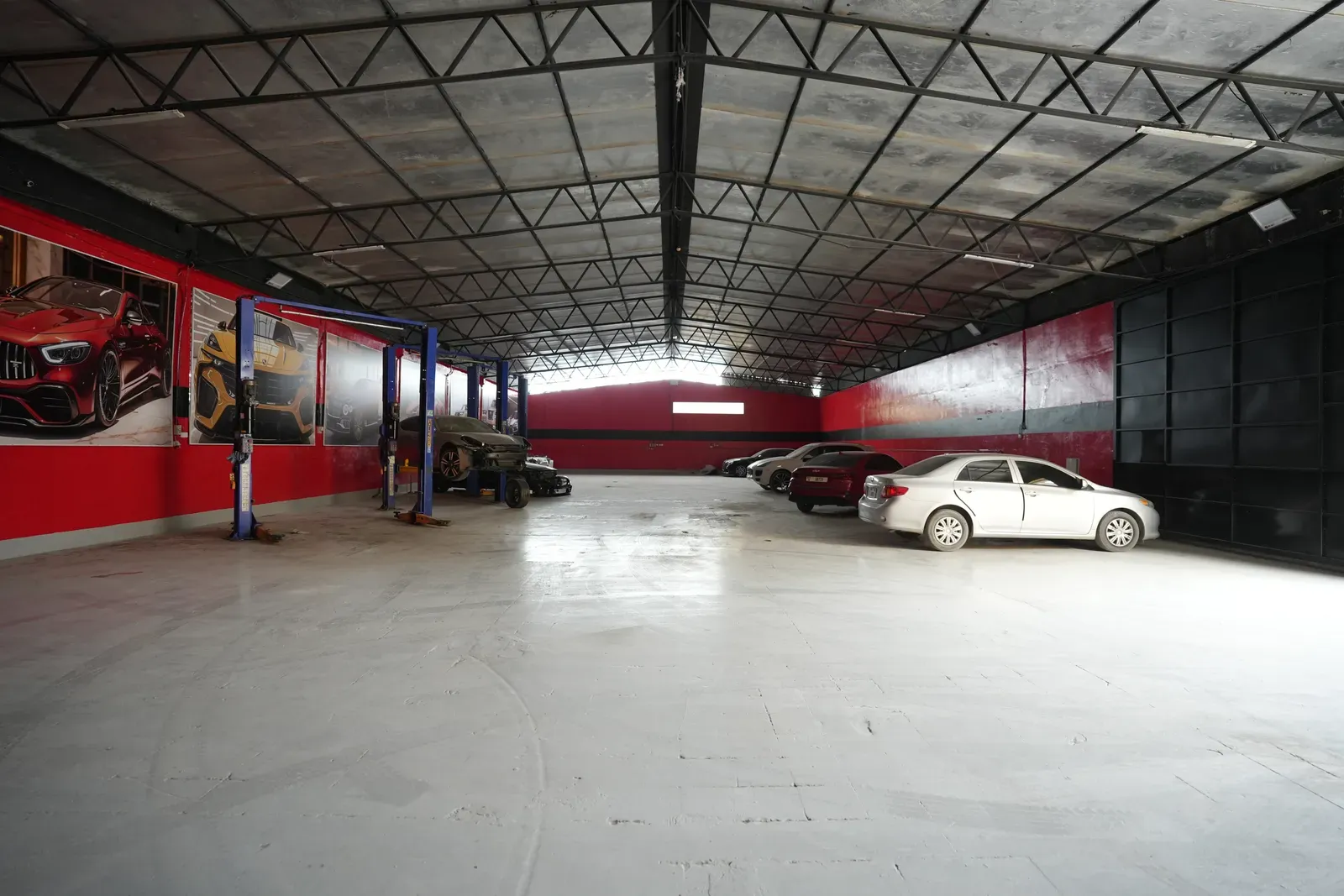 The workshop floor in Sharjah, looking down the bays past the lifts to the cars waiting at the far end.